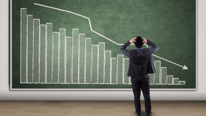 Stressful businessman looking at a declining graph Token sales